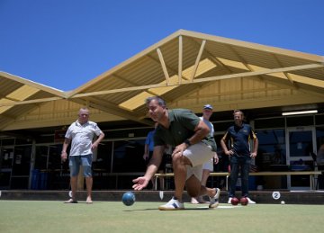 Image of Mayor Mark Irwin taking part in a game of lawn bowls. 