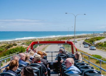 Image of visitors riding on the Coastal Explorer bus along the coast